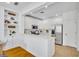 Clean kitchen with all-white appliances, white cabinets, and hardwood flooring at 1068 Lake Baldwin Ln, Orlando, FL 32814