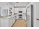 Well-equipped kitchen featuring white cabinetry, stainless appliances, and tile flooring at 1068 Lake Baldwin Ln, Orlando, FL 32814