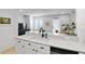 Stylish kitchen with sleek countertops, white cabinetry, modern appliances and breakfast bar at 1068 Lake Baldwin Ln, Orlando, FL 32814