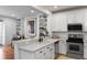 Bright and spacious kitchen with a breakfast bar, white cabinets and stainless steel appliances at 1068 Lake Baldwin Ln, Orlando, FL 32814