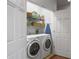 Convenient laundry room with a washer and dryer, shelving, and extra storage space at 1068 Lake Baldwin Ln, Orlando, FL 32814