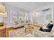 Bright living room with large windows, neutral furniture, and hardwood floors at 1068 Lake Baldwin Ln, Orlando, FL 32814