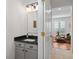 Stylish half bathroom with a black marble countertop and modern lighting fixtures at 1068 Lake Baldwin Ln, Orlando, FL 32814