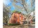 Exterior of a three-story building showcases brick and well-maintained landscaping with parking lot and trees at 107 Vista Verdi Cir # 237, Lake Mary, FL 32746