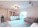 A spacious living room with plush seating, ample light, and a ceiling fan that adds a cozy touch at 107 Vista Verdi Cir # 237, Lake Mary, FL 32746