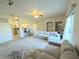 Bright living room with neutral tones, comfortable seating, and open-concept design flowing into kitchen space at 107 Vista Verdi Cir # 237, Lake Mary, FL 32746