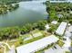 Aerial view of community featuring a lake, lush landscaping, and on-site amenities at 1140 S Orlando Ave # E-1, Maitland, FL 32751