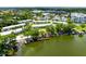 Aerial view of condos overlooking a pond with a community beach, boat slips and lake access at 1140 S Orlando Ave # E-1, Maitland, FL 32751