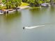 Scenic lake view with a personal watercraft on the water, surrounded by lush landscaping at 1140 S Orlando Ave # E-1, Maitland, FL 32751