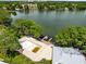 Aerial view of a property on a lake with pool and boat docks, offering waterfront living at 1140 S Orlando Ave # E-1, Maitland, FL 32751
