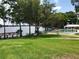Expansive backyard with lush green grass, a swimming pool and dock, ideal for outdoor recreation and relaxation at 1140 S Orlando Ave # E-1, Maitland, FL 32751