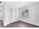 Bedroom with hardwood floors, white walls, a window, and bi-fold closet doors at 1140 S Orlando Ave # E-1, Maitland, FL 32751
