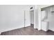 Bedroom showcasing new hardwood floors, white walls, and a washer/dryer closet at 1140 S Orlando Ave # E-1, Maitland, FL 32751