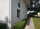 Exterior view of a well-maintained building with clean, white facade, green hedges, and a tidy sidewalk at 1140 S Orlando Ave # E-1, Maitland, FL 32751