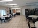 Spacious community room with ample seating, a bar area, and a bookcase creating a welcoming social space at 1140 S Orlando Ave # E-1, Maitland, FL 32751