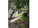 Exterior building view framed by trees, green lawn, and a sidewalk at 1140 S Orlando Ave # E-1, Maitland, FL 32751