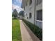 Exeter House featuring well-maintained landscaping, a sidewalk, and a clean, white facade at 1140 S Orlando Ave # E-1, Maitland, FL 32751