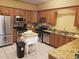 Well-equipped kitchen with stainless steel appliances, wooden cabinetry and granite countertops offering a functional cooking space at 1140 S Orlando Ave # E-1, Maitland, FL 32751
