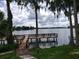 Community dock on the lake, framed by mature trees, offers the perfect spot to enjoy a relaxing day at 1140 S Orlando Ave # E-1, Maitland, FL 32751