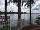 Scenic lake view featuring a white picket fence and mature trees with Spanish moss creating a tranquil waterfront setting at 1140 S Orlando Ave # E-1, Maitland, FL 32751