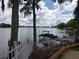 Beautiful lake view from the shoreline with a private boat dock and boat, showcasing waterfront living at its finest at 1140 S Orlando Ave # E-1, Maitland, FL 32751