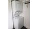 Compact laundry area with stacked washer and dryer, maximizing space efficiency in the home at 1140 S Orlando Ave # E-1, Maitland, FL 32751