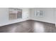 Living room with hardwood floors, white walls, a window with blinds and a front door at 1140 S Orlando Ave # E-1, Maitland, FL 32751