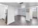 Open-concept living room with hardwood floors and access to the kitchen and bathroom at 1140 S Orlando Ave # E-1, Maitland, FL 32751