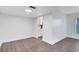 Spacious living room with wood-look flooring and a glimpse into the well-lit kitchen at 1140 S Orlando Ave # E-1, Maitland, FL 32751