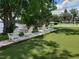 Community putting green with lakeside Adirondack chairs offers a relaxing outdoor amenity for residents and guests at 1140 S Orlando Ave # E-1, Maitland, FL 32751