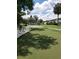 Scenic community putting green and shuffleboard court are surrounded by mature landscaping and condo buildings at 1140 S Orlando Ave # E-1, Maitland, FL 32751