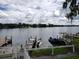 Beautiful lake view with docks, boats, and a serene waterfront setting on a cloudy day at 1140 S Orlando Ave # E-1, Maitland, FL 32751