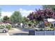 Scenic street view of the community, highlighting landscaped sidewalks, lush trees, and colorful flowering bushes at 1250 Water Maple Dr, Oakland, FL 34787