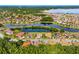 Expansive aerial view of a residential community featuring numerous homes and a serene lake at 132 Rosa Bella Vw, Debary, FL 32713