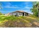 Expansive backyard with well-maintained lawn and view of the house's exterior, complete with a screened-in patio at 132 Rosa Bella Vw, Debary, FL 32713