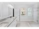 Bright bathroom with double vanity, glass-enclosed shower, and modern finishes at 132 Rosa Bella Vw, Debary, FL 32713