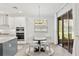 Dining area with table and chairs near kitchen and sliding glass door to backyard at 132 Rosa Bella Vw, Debary, FL 32713