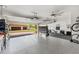 Spacious garage with epoxy flooring, weight rack and bike. Doubles as a home gym at 132 Rosa Bella Vw, Debary, FL 32713