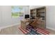 Bright home office featuring custom built-ins, wood desk, and window view at 132 Rosa Bella Vw, Debary, FL 32713