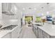 Well-lit kitchen showcasing stainless steel appliances, a large island, and an open layout at 132 Rosa Bella Vw, Debary, FL 32713