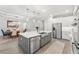 Spacious kitchen island with seating, stainless steel appliances, and ample counter space for cooking and entertaining at 132 Rosa Bella Vw, Debary, FL 32713