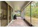 Spacious screened lanai featuring brick flooring, glass sliding doors and views of the backyard at 132 Rosa Bella Vw, Debary, FL 32713