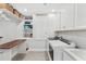 Well-organized laundry room with ample storage, folding counter, and modern washer and dryer at 132 Rosa Bella Vw, Debary, FL 32713
