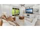 Comfortable living room featuring built-in shelving, a large sectional, and access to the outdoor patio at 132 Rosa Bella Vw, Debary, FL 32713