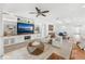 Comfortable living room with built-in shelving, a ceiling fan, and stylish furniture at 132 Rosa Bella Vw, Debary, FL 32713