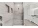 Luxurious tiled shower with rainfall showerhead, bench, and niche, providing a spa-like experience at 132 Rosa Bella Vw, Debary, FL 32713