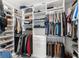 Spacious walk-in closet with custom shelving and ample hanging space for optimal organization at 132 Rosa Bella Vw, Debary, FL 32713