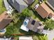 Overhead aerial view of a home with a swimming pool, solar panels, and outdoor entertaining area at 13214 Triphammer Way, Orlando, FL 32828