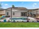 Exterior view of home showcasing the pool, patio, and landscaped yard at 13214 Triphammer Way, Orlando, FL 32828