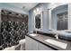 Bathroom featuring double sink vanity with granite countertop and shower with black floral curtain at 13214 Triphammer Way, Orlando, FL 32828